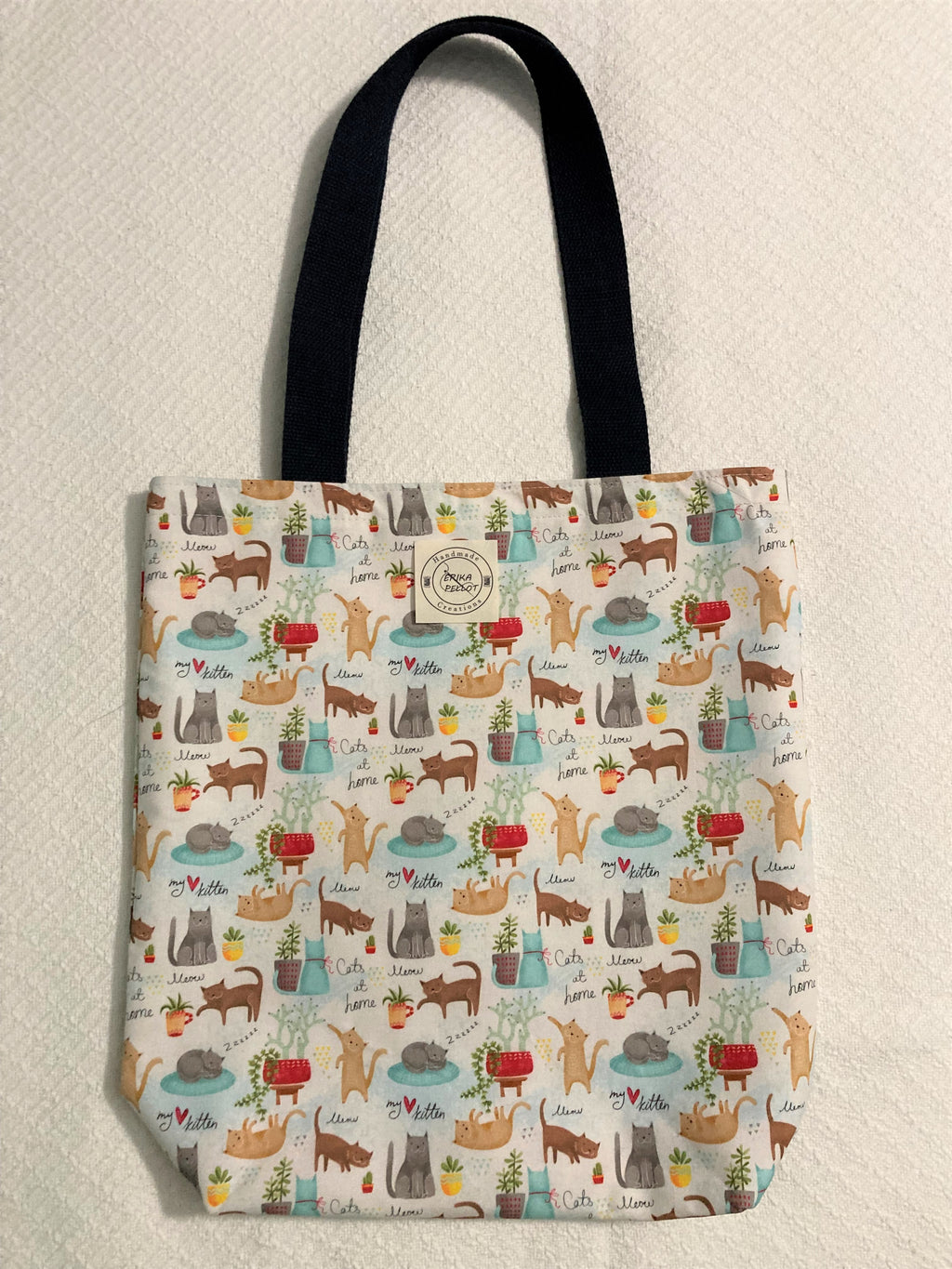 This small tote bag is purr-fectly lined with cute cats and fun kitties! Crafted with 100% cotton, it's sure to be a meow-velous addition to your ensemble! Meow-yow, what are you waiting for?  All the materials are 100% cotton making it a sustainable item. This cute handmade tote bag is around 15 inches wide and 18 inches long with a 4 inch bottom.