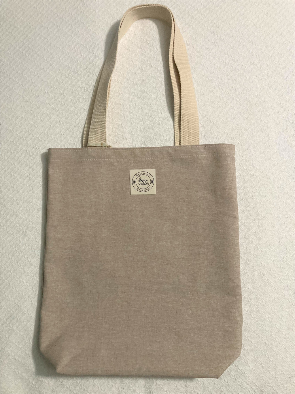 Your wardrobe won't miss a beat with this cool, light brown linen small tote! Fun and sustainable, this tote is perfect for the fashion-savvy conscious consumer. No blah-blah-blah here, just style and sustainability!  All the materials are 100% cotton making it a sustainable item. This cute handmade tote bag is around 15 inches wide and 18 inches long with a 4 inch bottom.