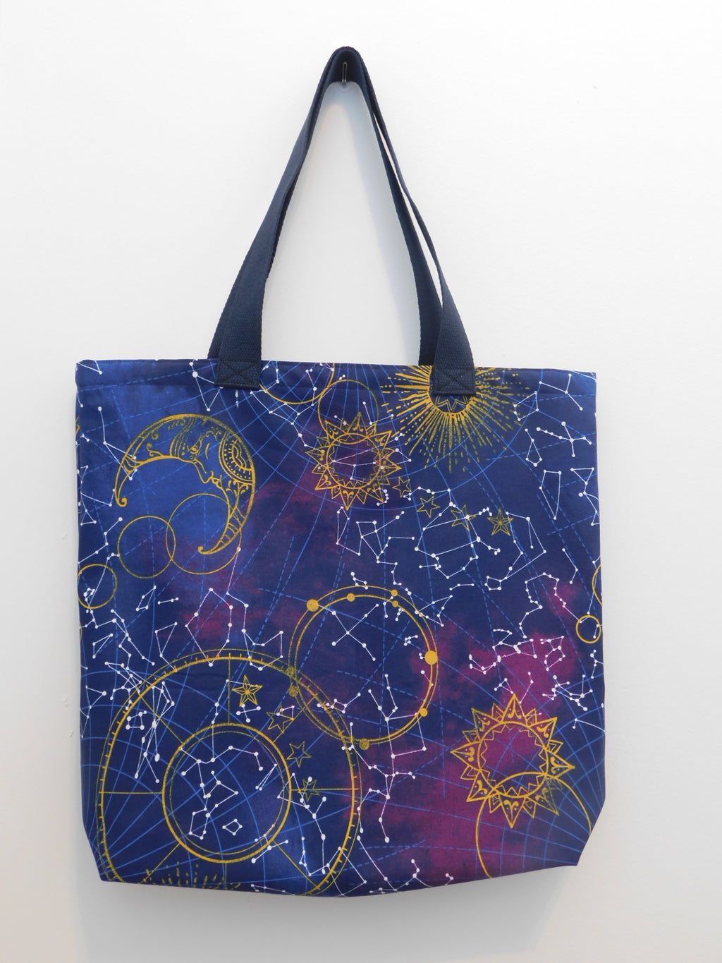 Perfect tote bag for those who love space! This tote has beautiful depictions of the sun, the moon, and constellations. All in a blue and purple background. Perfect to use year-round to go anywhere. Good for going shopping and reducing the use of plastic, travel, or just gift to someone you care about. The fabric, muslin lining, thread and trim are all 100% cotton. For care, machine was gentle cold, non-chlorine bleach, tumble dry low, and cool iron. Measurements are around 16in x 19in x 4in.