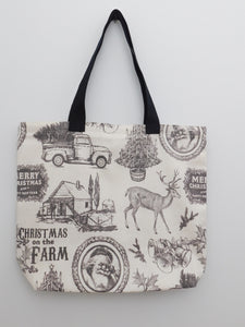 Old school holidays! This beautiful lined handmade tote bag depicts images of and old truck with a pine tree in the back, a deer, an old frame with Santa's portrait, the phrases "Merry Christmas and a Happy New Year", and "Christmas on the farm", bells and hollies, and a Christmas tree in a short barrel. All images are in a light dark brown in a cream colored background. All the materials; duck cloth fabric, muslin lining, black trim, and thread are 100% cotton. Measurements are around 16in x 19in x 4in.