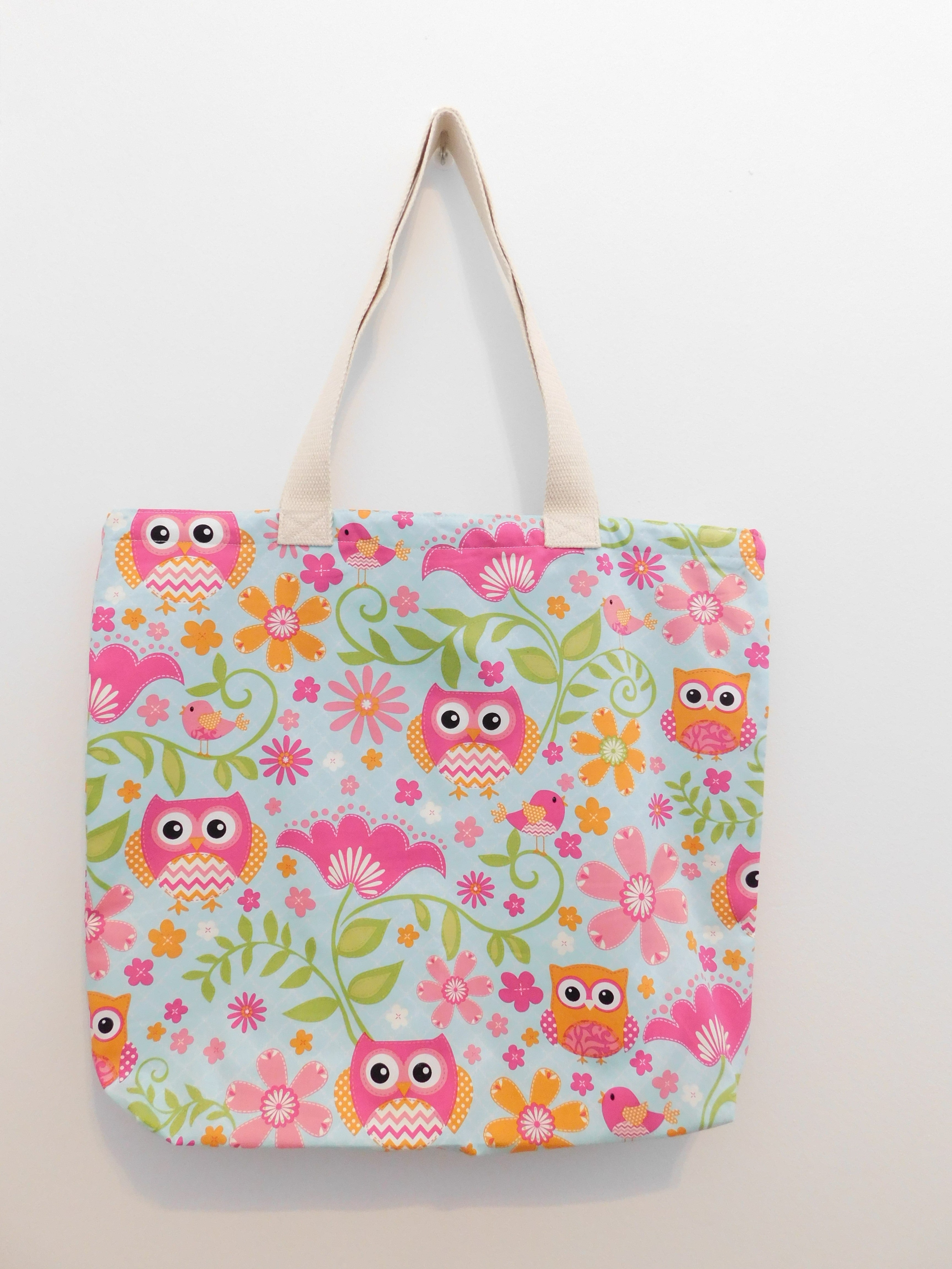 This beautiful handmade summer tote bag has cute owls, birds and flowers in hues of pink, orange and white in a light turquoise background with green leaves. Natural color trim, muslin lining, fabric and thread are all 100% cotton. Machine wash warm, delicate cycle, tumble dry low, use cool iron, do not bleach. Measurements are around 19in x 16in x 3in.