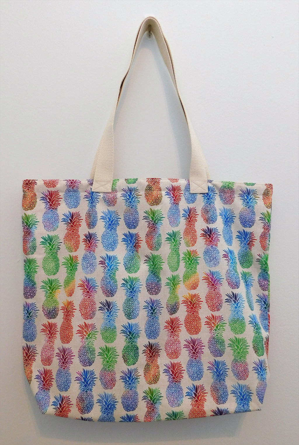 Rainbow pineapples! Almost like a hologram with your red, green, blue, orange and purple colors. Talk about a fun handmade tote bag! Great tote to travel with, carry school books, art supplies or give as a cool gift. All materials from the fabric, muslin lining, thread, and trim are all 100% cotton. Measurements are around 16in x 19in x 4in. To care for your tote machine wash gentle cold, non-chlorine bleach, tumble dry low, cool iron.