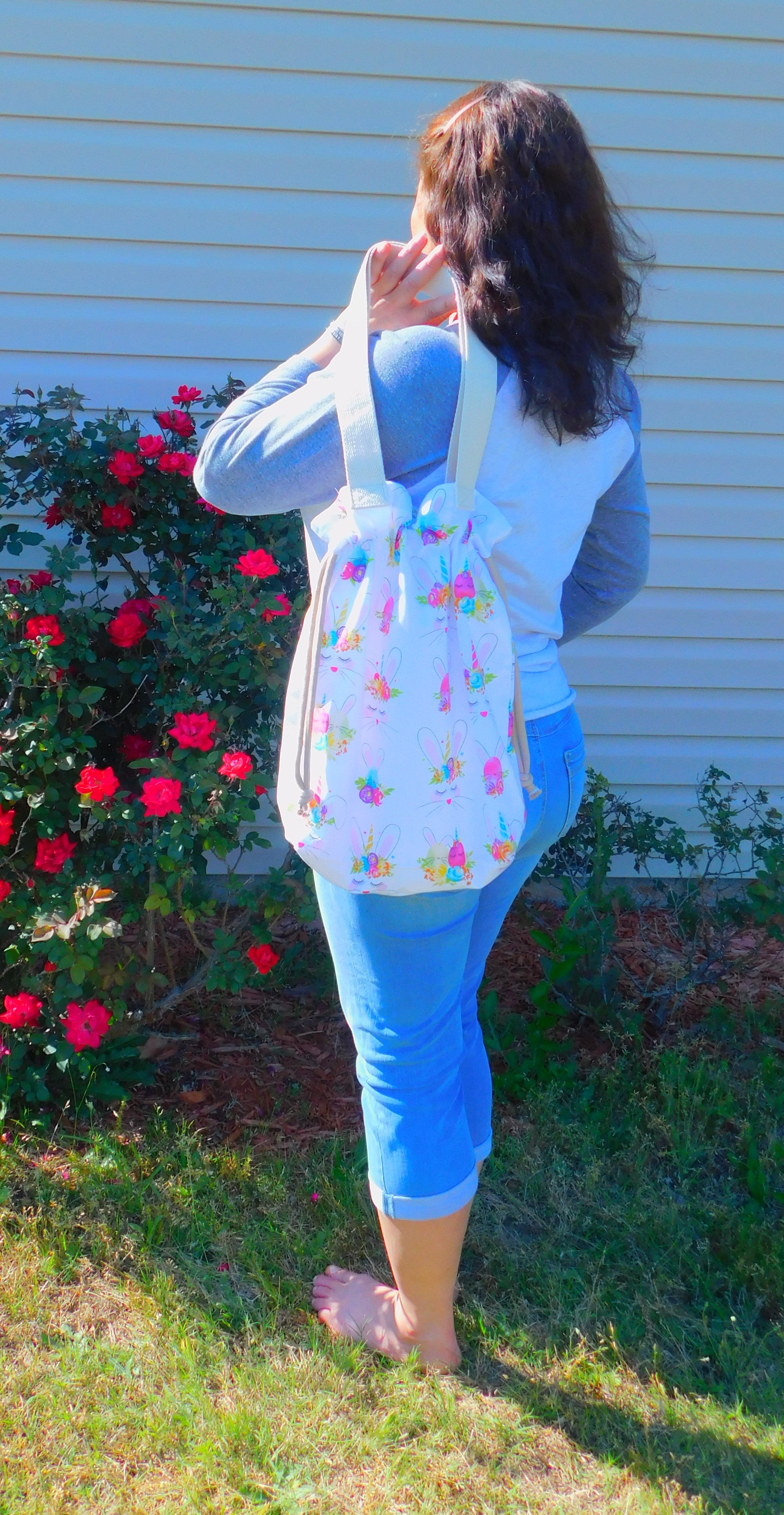 Mix a bunny and a unicorn and we have a Bunnycorn! This cute tote has bunnies with unicorn horns and the also have flower crowns with red, blue, purple flowers.  The pocket is inside and is big enough to fit a cell phone and keys. Fabric, muslin lining, thread and trim are 100% cotton. To care for your tote machine wash warm, tumble dry low, remove promptly and no bleach. Measurements are around 16in x 14 1/2in x 4in.